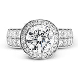 With a beautiful halo surrounding the center stone, this lovely white gold engagement ring is set with 1.14 ctw of shimmering princess cut white diamonds and .20 ctw round cut white diamonds.
