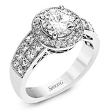 With a beautiful halo surrounding the center stone, this lovely white gold engagement ring is set with 1.14 ctw of shimmering princess cut white diamonds and .20 ctw round cut white diamonds.