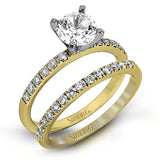 Featuring a modern take on a classic design, this white gold engagement ring and wedding band are inset with .58 ctw of glimmering round cut white diamonds.