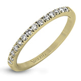 Featuring a modern take on a classic design, this white gold engagement ring and wedding band are inset with .58 ctw of glimmering round cut white diamonds.