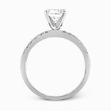 Featuring a modern take on a classic design, this white gold engagement ring and wedding band are inset with .58 ctw of glimmering round cut white diamonds.