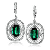 These exquisite vintage-inspired 18k white gold earrings contain delicate filigree and 1.12 ctw of white diamonds surrounding a gorgeous 7.12 ctw of green tourmaline.
