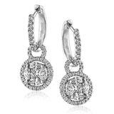 Featuring .50 ctw marquise cut white diamonds, .20 ctw princess cut white center diamonds, and .49 ctw round cut white diamonds set in white gold, these eye-catching contemporary earrings make a dramatic statement.