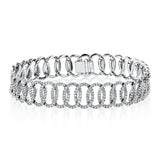 This stylized bangle bracelet sparkles with 3.73 ctw of shining white diamonds.