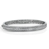 This 18k bangle provides extra sparkle with .93 ctw of round white diamonds in rows flanking 3.19 ctw of princess cut white diamonds.