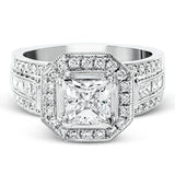 The dramatic contemporary design of this white gold ring is highlighted by .59 ctw of round cut white diamonds and .36 ctw princess cut diamonds.