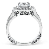 The dramatic contemporary design of this white gold ring is highlighted by .59 ctw of round cut white diamonds and .36 ctw princess cut diamonds.