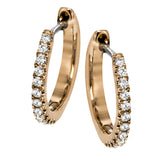 Featuring a classic hoop style with modern accents, these sparkling white gold earrings are accentuated by .17 ctw of round cut white diamonds.