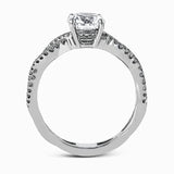 The intricate twisted design of this modern white gold engagement ring and wedding band set is set with .65 ctw of striking round cut white diamonds.