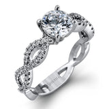 The intricate twisted design of this modern white gold engagement ring and wedding band set is set with .65 ctw of striking round cut white diamonds.