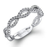 The intricate twisted design of this modern white gold engagement ring and wedding band set is set with .65 ctw of striking round cut white diamonds.