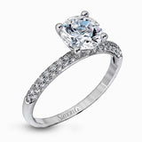 Presenting an eye-catching modern design, this white gold engagement ring and wedding band are highlighted by 1.45 ctw of round cut white diamonds.