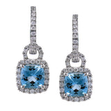 These stunning earrings feature cushion cut Aquamarines 1.53 ctw., surrounded by a halo of diamonds that dangle from diamond huggies 0.45 ctw