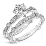 Featuring a dazzling contemporary design, this elegant white gold engagement ring and wedding band set is accented by .59 ctw of round cut white diamonds.