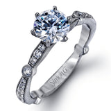 Featuring a dazzling contemporary design, this elegant white gold engagement ring and wedding band set is accented by .59 ctw of round cut white diamonds.