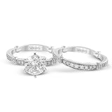 Featuring a dazzling contemporary design, this elegant white gold engagement ring and wedding band set is accented by .59 ctw of round cut white diamonds.