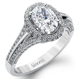 This lovely 18k white gold engagement ring design is created for an elegant oval center stone and features .77 ctw of white diamonds accented by a small touch of .03 ctw of yellow diamonds.