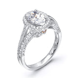This lovely 18k white gold engagement ring design is created for an elegant oval center stone and features .77 ctw of white diamonds accented by a small touch of .03 ctw of yellow diamonds.