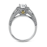 This lovely 18k white gold engagement ring design is created for an elegant oval center stone and features .77 ctw of white diamonds accented by a small touch of .03 ctw of yellow diamonds.