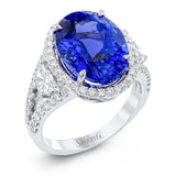 This wonderful 18k white gold vintage-inspired ring contains .57 ctw of half moon diamonds flanking the center 7.83 ct tanzanite, accented by .67 ctw of white round diamonds.