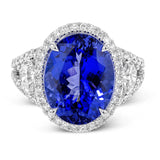 This wonderful 18k white gold vintage-inspired ring contains .57 ctw of half moon diamonds flanking the center 7.83 ct tanzanite, accented by .67 ctw of white round diamonds.
