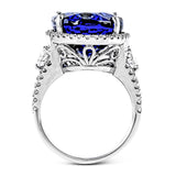 This wonderful 18k white gold vintage-inspired ring contains .57 ctw of half moon diamonds flanking the center 7.83 ct tanzanite, accented by .67 ctw of white round diamonds.