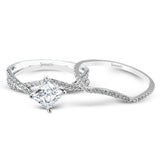 This dramatic white gold engagement ring and wedding band set are highlighted by .23 ctw of dazzling round cut white diamonds in a distinctive modern twist design.