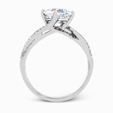 This dramatic white gold engagement ring and wedding band set are highlighted by .23 ctw of dazzling round cut white diamonds in a distinctive modern twist design.