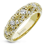 This lacy vintage inspired white gold band features .62 ctw of round cut white diamonds in a charming floral design.
