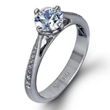 The elegant design of this classic white gold engagement ring and wedding band is complemented by .21 ctw of glimmering round cut white diamonds.