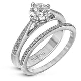The elegant design of this classic white gold engagement ring and wedding band is complemented by .21 ctw of glimmering round cut white diamonds.