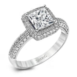 This vintage-inspired 18k white gold engagement ring is the perfect design for princess cut center stone because it has a detailed square shaped halo. The entire ring is set with .62 ctw of white diamonds.