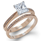 Featuring a simple, elegant classic design, this white gold engagement ring and wedding band is set with .16 ctw of round cut white diamonds.