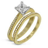 Featuring a simple, elegant classic design, this white gold engagement ring and wedding band is set with .16 ctw of round cut white diamonds.