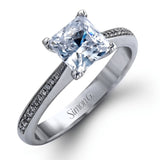 Featuring a simple, elegant classic design, this white gold engagement ring and wedding band is set with .16 ctw of round cut white diamonds.