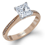Featuring a simple, elegant classic design, this white gold engagement ring and wedding band is set with .16 ctw of round cut white diamonds.