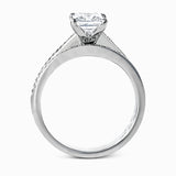 Featuring a simple, elegant classic design, this white gold engagement ring and wedding band is set with .16 ctw of round cut white diamonds.