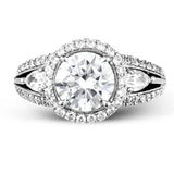 Reflecting a charming vintage design, this dazzling white gold engagement ring features .63 ctw of round cut white diamonds and .51 ctw of pear shaped white diamonds.