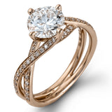 This sparkling modern white gold engagement ring and wedding band set features an eye-catching twisted design accented by .22 ctw of shimmering round cut white diamonds.
