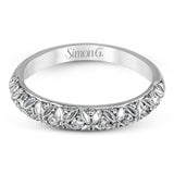This intricate band has a floral, nature-inspired design and contains .32 ctw of white diamonds.
