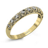 This intricate band has a floral, nature-inspired design and contains .32 ctw of white diamonds.