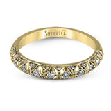 This intricate band has a floral, nature-inspired design and contains .32 ctw of white diamonds.