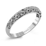 This intricate band has a floral, nature-inspired design and contains .32 ctw of white diamonds.