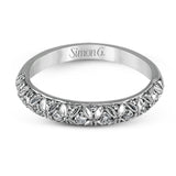 This intricate band has a floral, nature-inspired design and contains .32 ctw of white diamonds.
