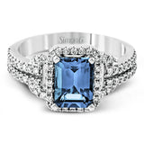 This elegant white gold contemporary ring is set with an arresting 1.31 ctw center aquamarine highlighted by .42 ctw round cut white diamond accents.
