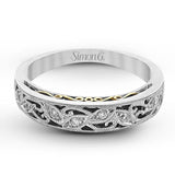 Featuring a delicate, intricate vintage style, this white gold wedding band is set with .09 ctw of shimmering white diamonds.