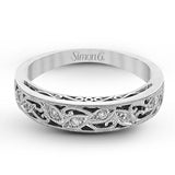 Featuring a delicate, intricate vintage style, this white gold wedding band is set with .09 ctw of shimmering white diamonds.