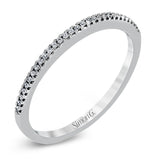 Playful and modern, this white gold wedding set sparkles with .31 ctw of round white diamonds highlighting the center stone.