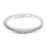 Playful and modern, this white gold wedding set sparkles with .31 ctw of round white diamonds highlighting the center stone.