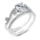 Playful and modern, this white gold wedding set sparkles with .31 ctw of round white diamonds highlighting the center stone.